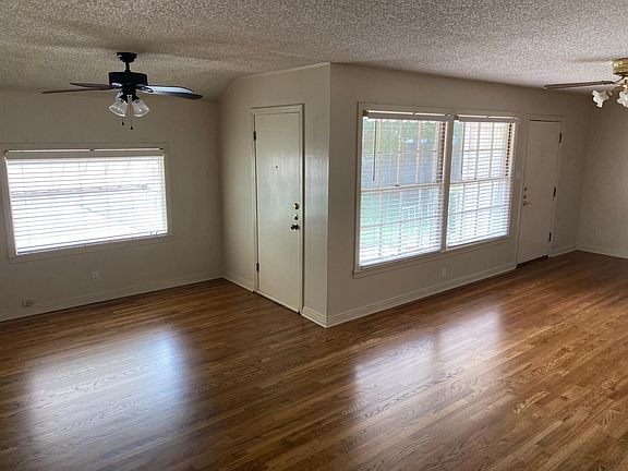 Large living area with hard wood floors.