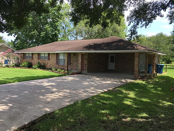 Double carport with entry to kitchen and utility room.