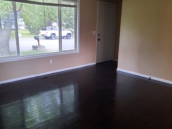 living room with hardwood floors and big window