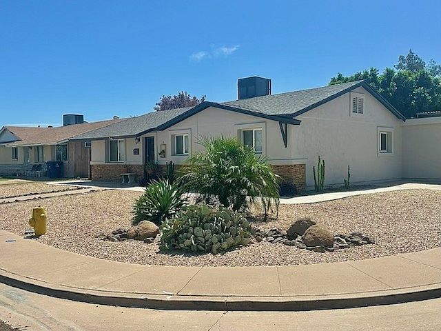 Fully Furnished Tempe Rental Home Corner View. Fully renovated , gravel front yard with low maintenance desert landscape with palm trees, cactus and blue Arizona skies. Monthly furnished Tempe rental property