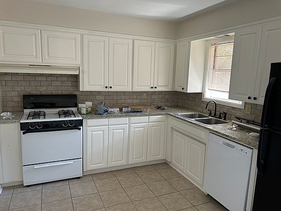 Updated kitchen with stove, refrigerator and dishwasher.