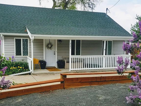 Low-maintenance landscaping. with lilacs, native flowers and apple trees.