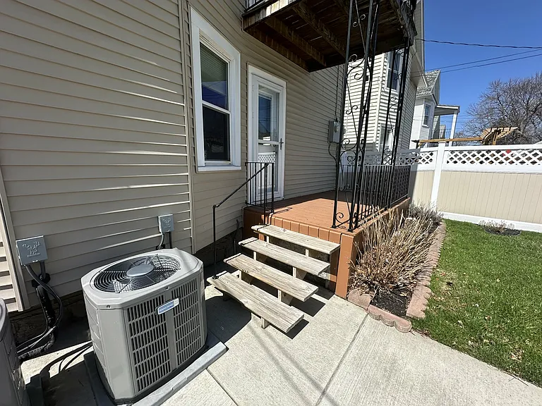 Private rear entrance with deck_easy access to the backyard and parking area.