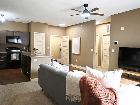 Modern kitchen and living room in a model unit at The Sterling at Grand Island.