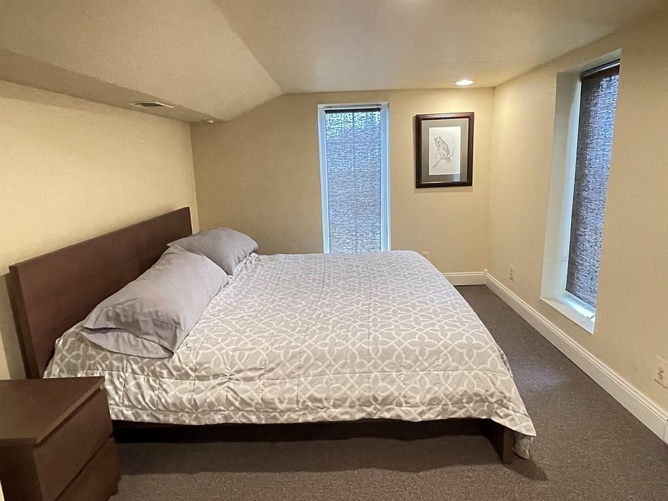 Bed area (king) with large windows, ceiling mounted reading lights, 2 nightstands