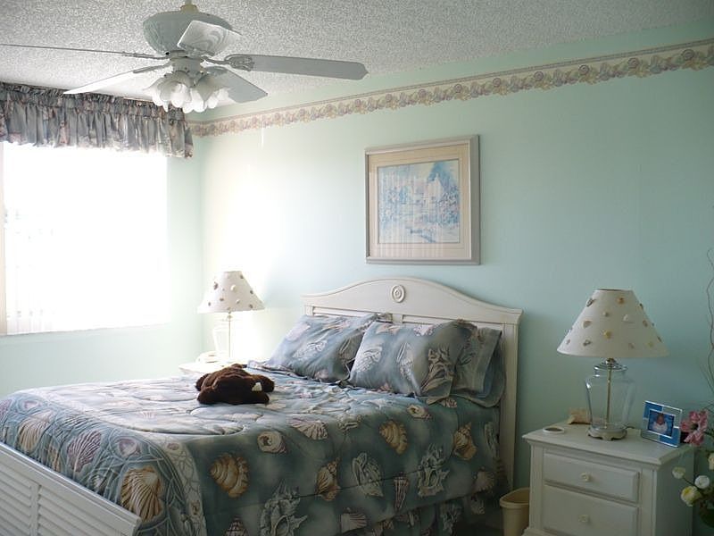 MASTER BEDROOM ALL TILE VIEW OF CANAL LIGHT COLORED WALLS