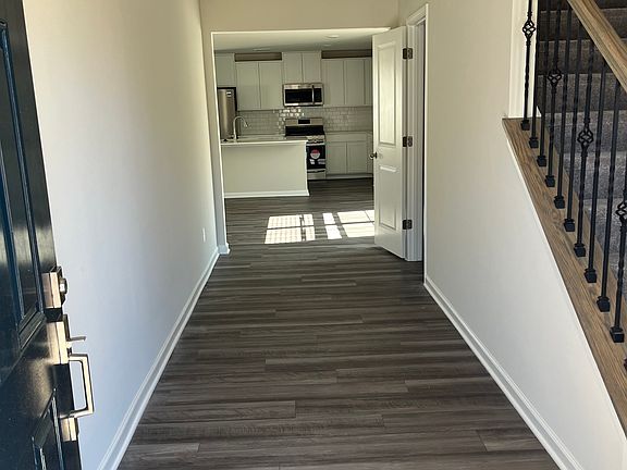 Large entry foyer with half bath to the right .