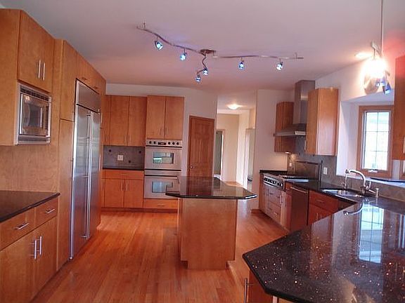 designer kitchen w/ custom birch cabinets, upgraded SS appl, granite counters