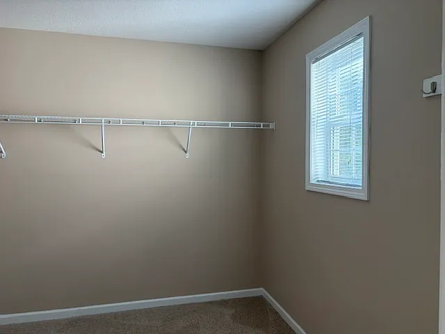 Walk-in closet is light filled and very generously sized