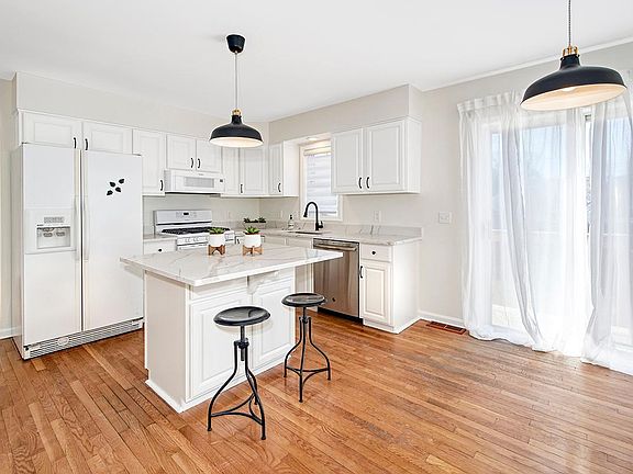 Renovated Eat-in-Kitchen, Features Quartz Countertops, Center Island & Sliders Out to Deck.