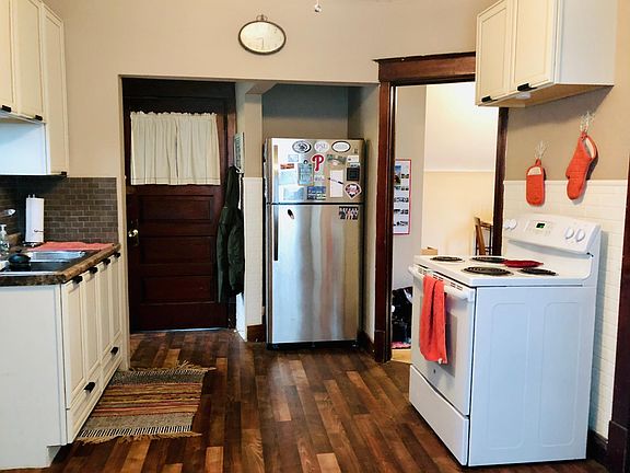 Kitchen w/ stainless steel fridge/freezer and stove