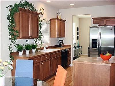 Kitchen with nook, gleaming hardwood floors, tile counter tops and two pantrie