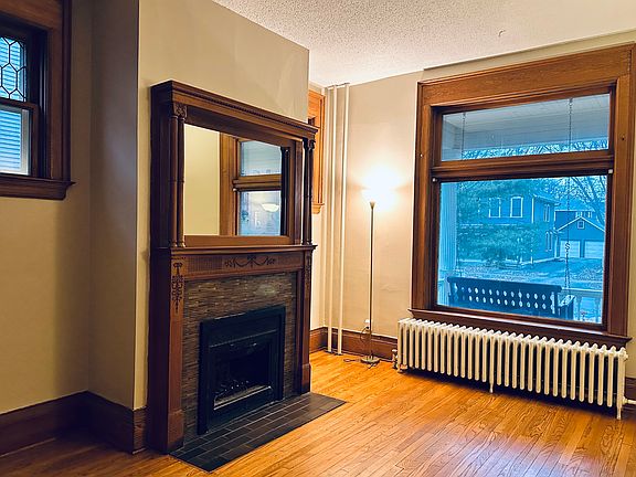 Living room with large windows providing natural light. (The fireplace is non-functioning currently.)