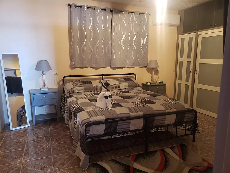 King Size bed with a smart TV in bedroom