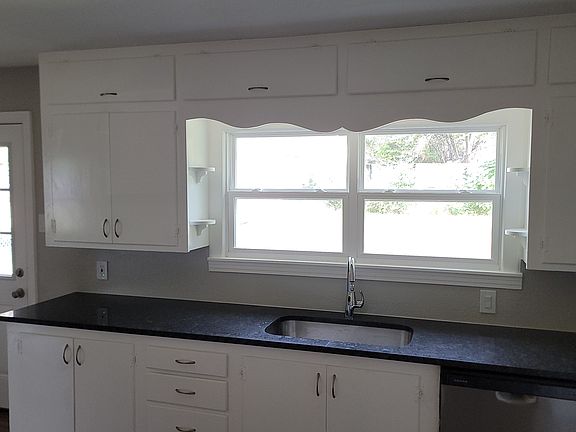 Kitchen has view of backyard.