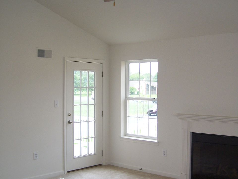 Vaulted ceiling and fan in living room.