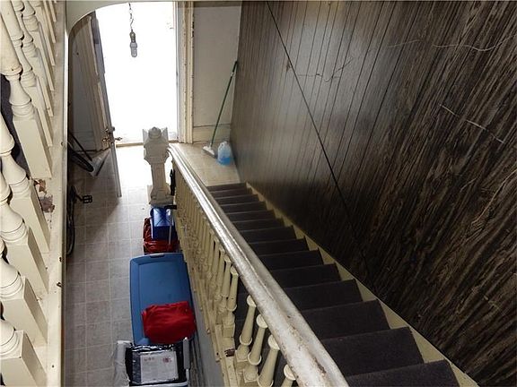 a view from the upstairs unit to the foyer, right now there is a washer and dryer in the hallway