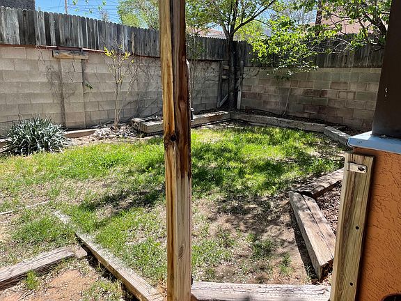 Winter view of private yard w/ planting beds