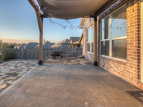Covered pergola and firepit to enjoy your views of the park.