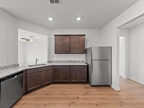 The kitchen has gorgeous wood cabinetry.