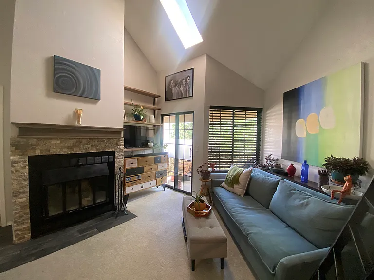 Living room with skylight and balcony.