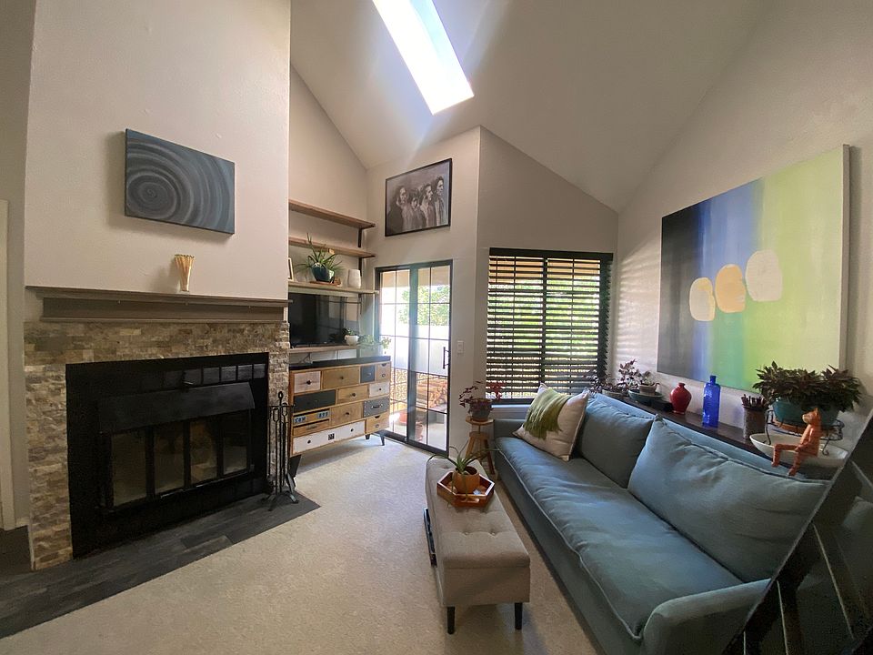 Living room with skylight and balcony.