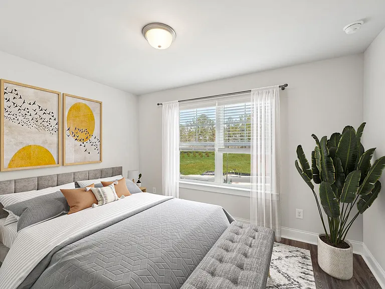 Another suite with a queen size bed and large window letting in a ton of natural light.