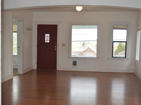 Living area with front door, on the left side is the door to