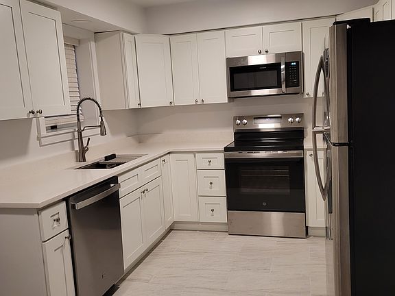 NEW KITCHEN! With Quartz Counters, Stainless Steel Appliances, Porcelain floor....cabinets and storage