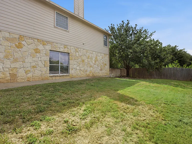 Large wooden deck, covered patio and large grassy section