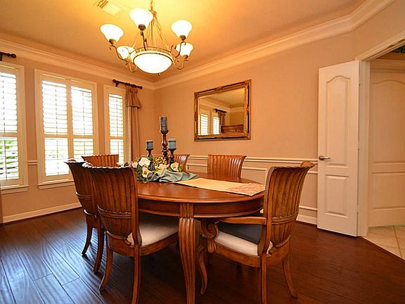 Large formal dining room has plenty of natural light coming in from the windows.