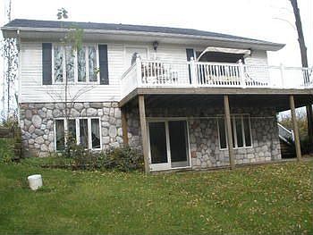 View from the backyard, notice the stone inlay, large deck and patio below
