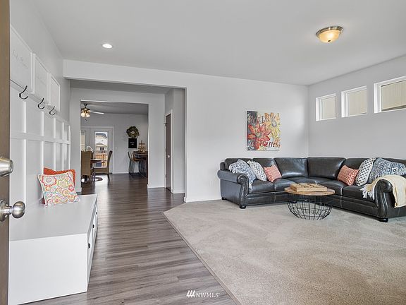 The entry to this home is both beautiful and practical, with hearty luxury vinyl flooring and open concept design.