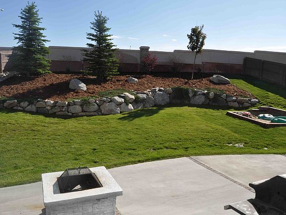 Backyard w/ patio and built-in sandbox.
