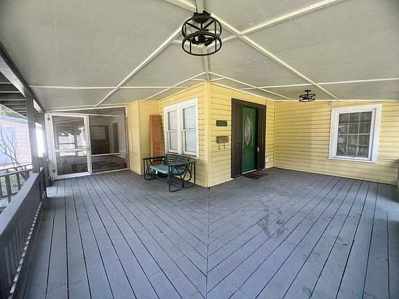 There is a really large porch that has been freshly painted.