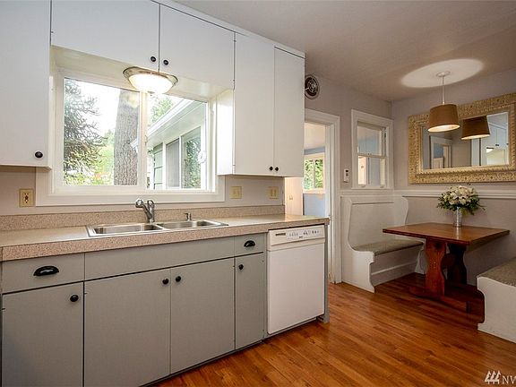 Easy care laminate flooring in kitchen/living room/dining room and main level bedroom.