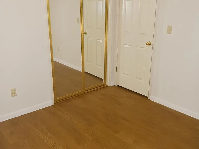 Bedroom and closet with sliding mirror door.