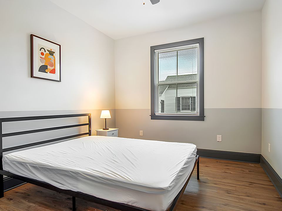 Spacious room furnished with queen size bed, ceiling fan and nightstand