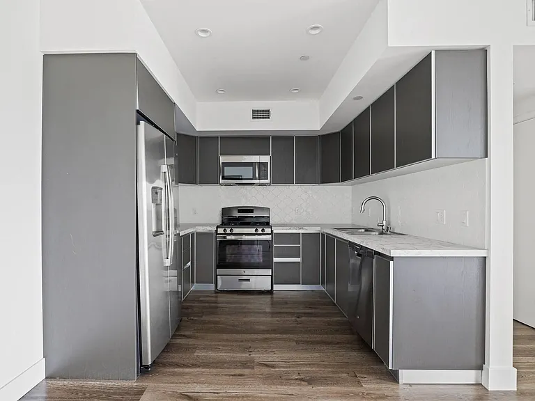 Full-Size Kitchen with Stainless-Steel Refrigerator, Stove, Microwave Oven, and Dishwasher