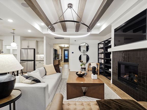 Gathering Room with Tray Ceiling and Transitional Fireplace