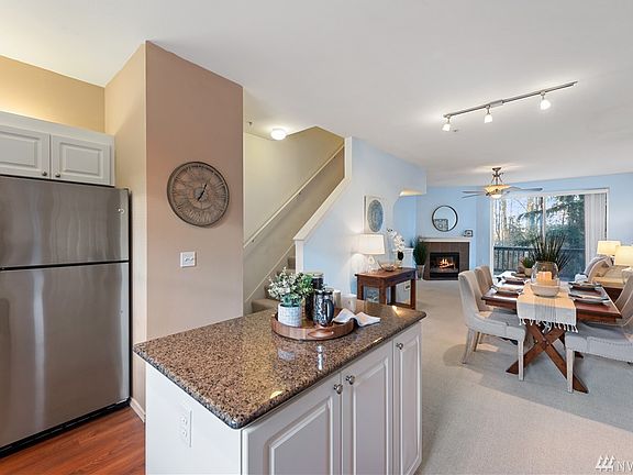 Granite counters, stainless appliances and open concept kitchen flows into dining and living areas.