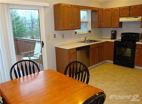 The kitchen features brand new flooring, wood cabinets and a walk-out to the deck. The dishwasher is