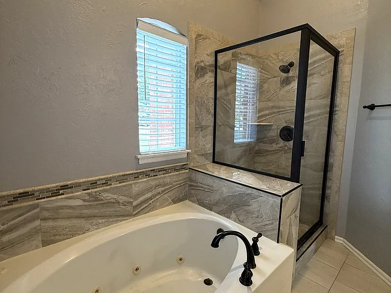 Jetted tub and shower in the master bathroom.