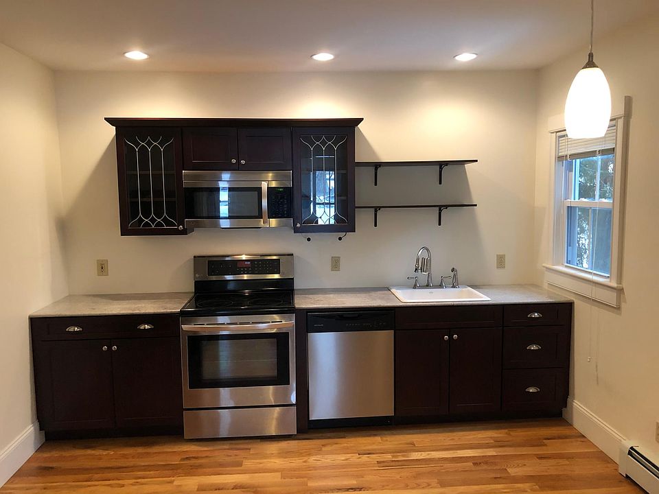 Granite kitchen with cherry cabinets and hardwood floors. 
1 of 2 kitchen windows opening to courtyard