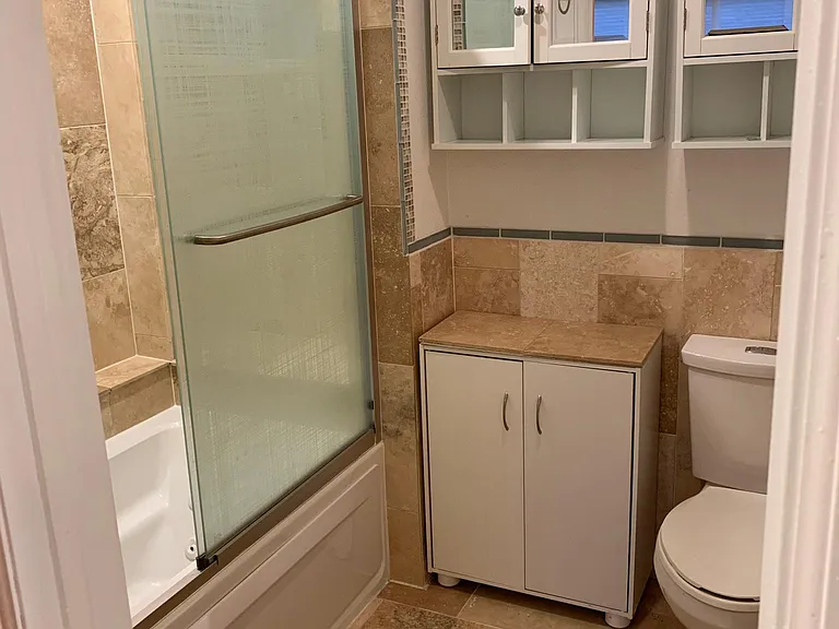 Master on suite bathroom with custom, hand laid radiant heat tile and remodeled shower with mosaic tile and jacuzzi tub, rain shower, and body sprayers, low flow toilet