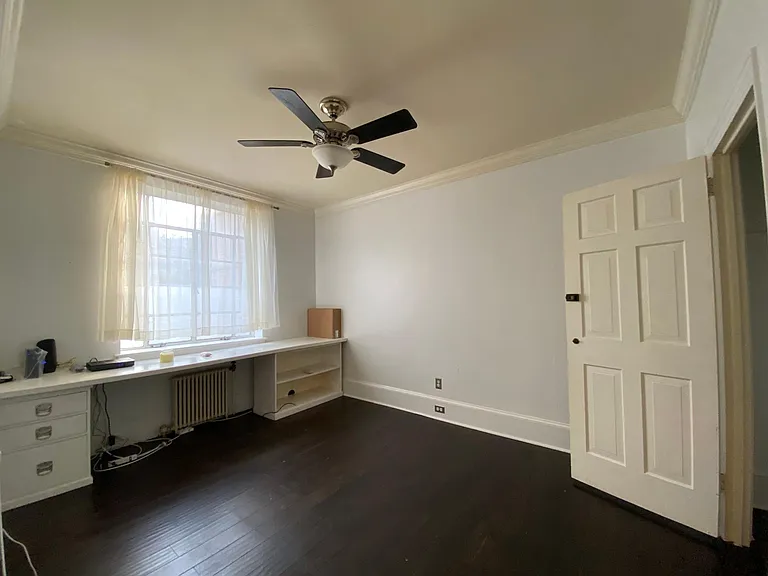 bedroom w/ built-in desk (which has since been removed to allow for even more space), ceiling fan, spacious closet, new curtains and fresh paint