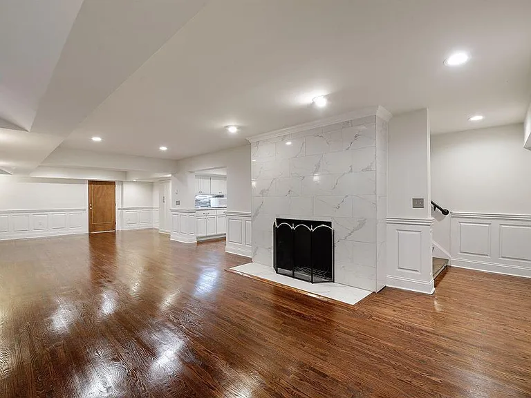 Unfurnished view of family room area and stairway from the main level (right)