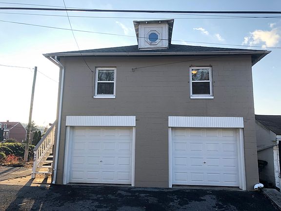 View from Apple st. Apartment on second floor, and one garage bay included.