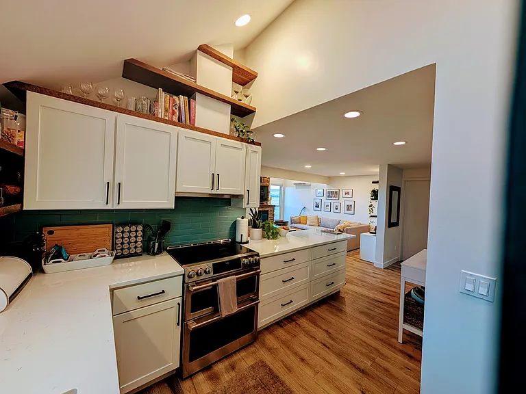 Kitchen with view of the living area. Skylight offers natural light.