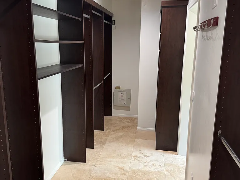 Downstairs primary bedroom walk in closet